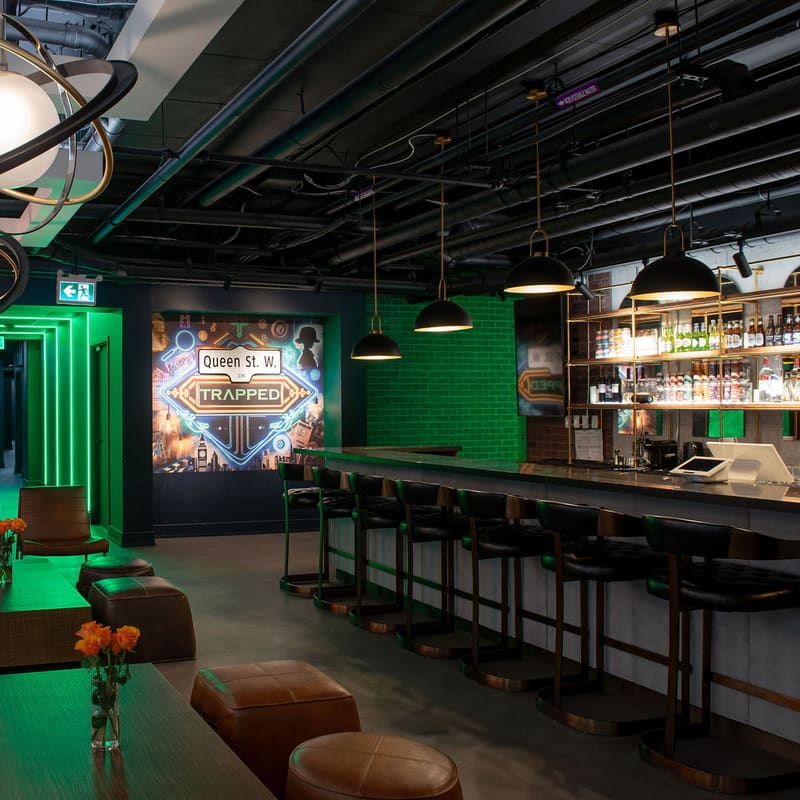 The lounge and licensed bar, with room posters along the concrete wall