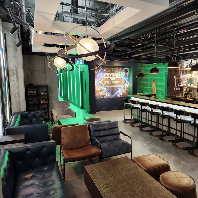 The full lounge seen from the entrance, bar running down the right